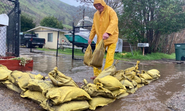 Storm blocks roads, brings snow, rain