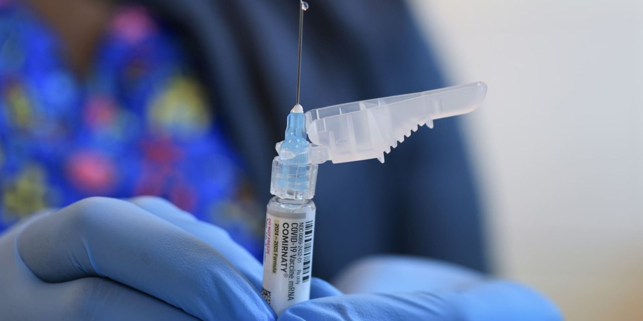 Covid Shot Access, cover at the game, while the vaccine panel by RFK Jr.